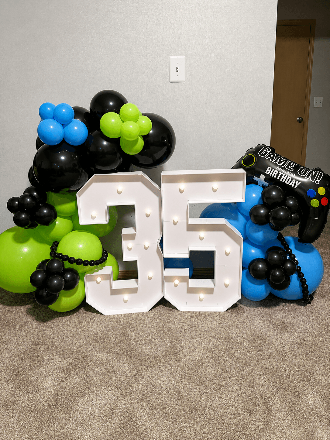 Gaming-themed balloon numbers and decor for a 35th birthday celebration