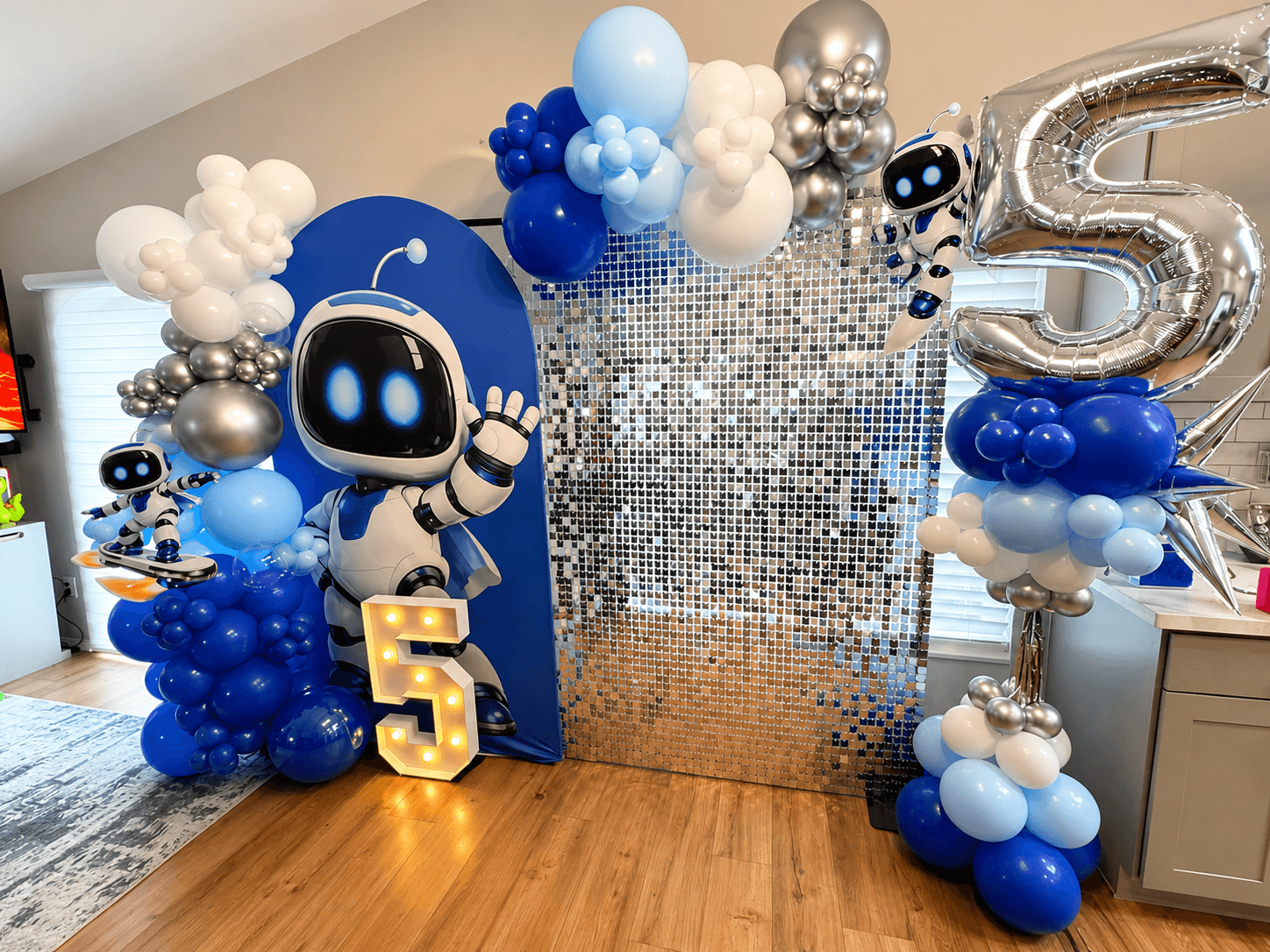 Astronaut-themed shimmer wall backdrop for a 5th birthday party